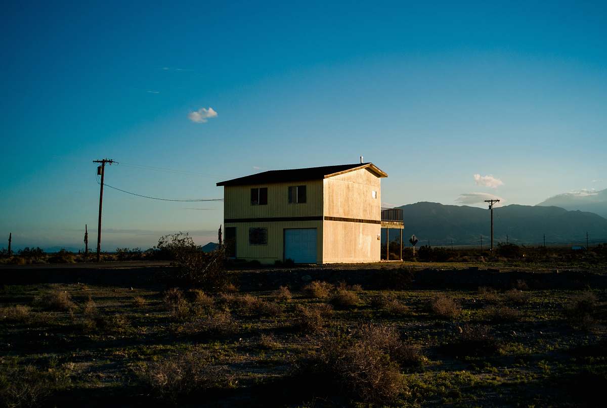 salton city low-angle photography of house beside street countryside